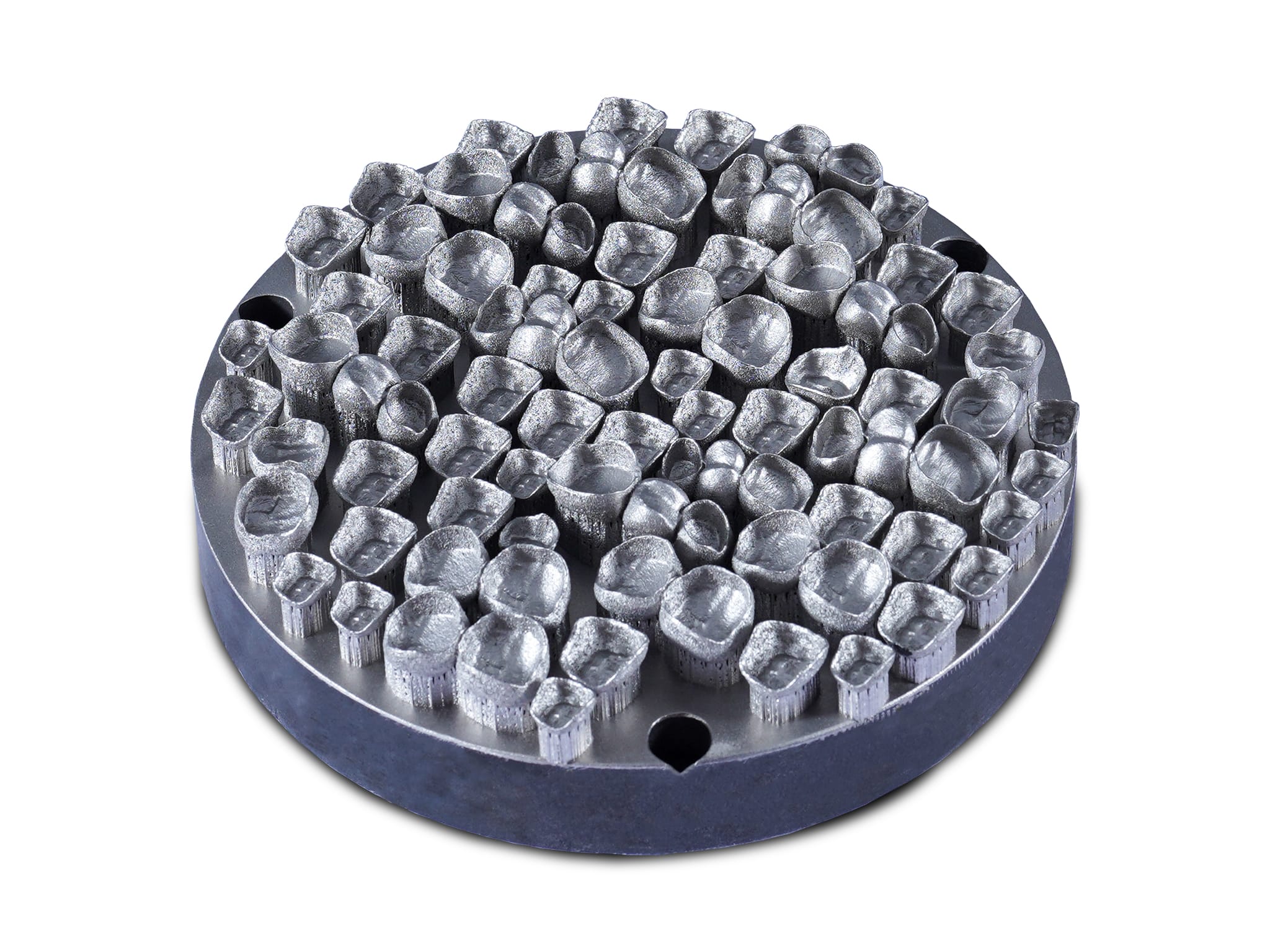 Metal 3D-printed dental crowns arranged on a build plate, showcasing precision and consistency in additive manufacturing.